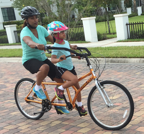 Mother and daughter ride Buddy Bike alternative tandem bike